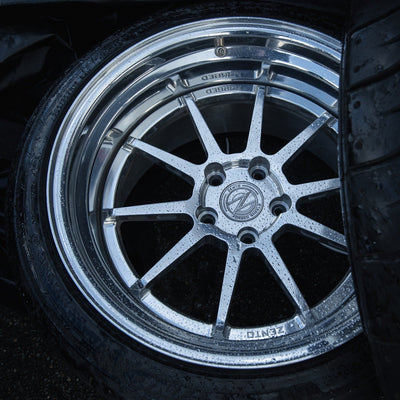 3 piece forged aluminium wheel with hidden hardware at a drift motorsport racing paddock with rain beeding