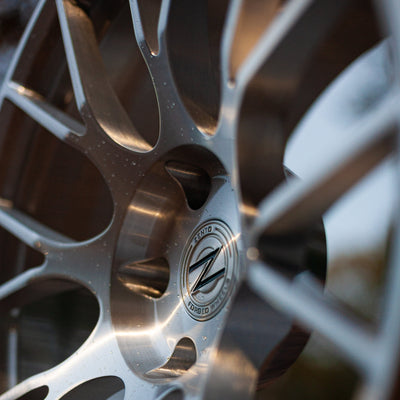Zento MS3 Monoblock Forged Aluminium Wheel close up finished in brushed silver, in British autumnal woodland