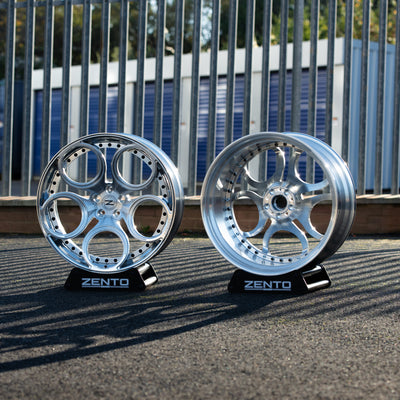 Pair of Forged Aluminium Multipiece wheels, showing metal centre cap and split rim hardwear 
